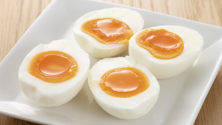 cut soft boiled eggs on plate