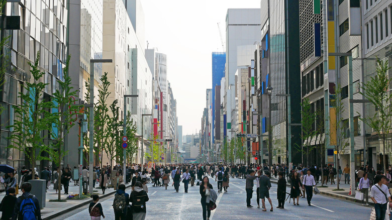 road in Ginza with people walking and skyscrapers lining the street