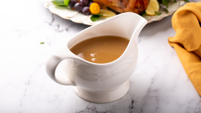 A gravy boat on a table set for Thanksgiving dinner