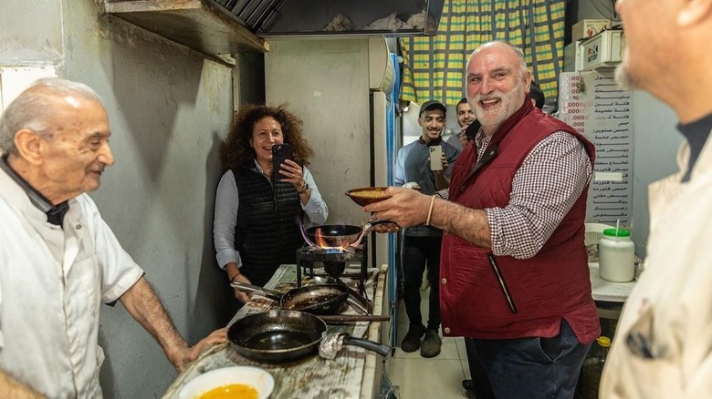 José Andrés with several people in a kitchen