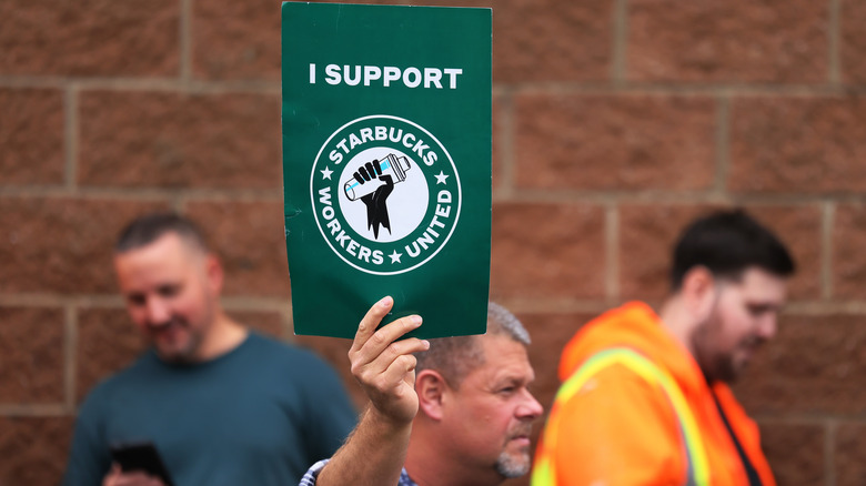 Man holding Starbucks Workers United sign