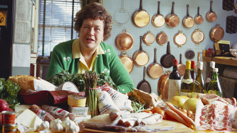 Julia Child in front of copper pans