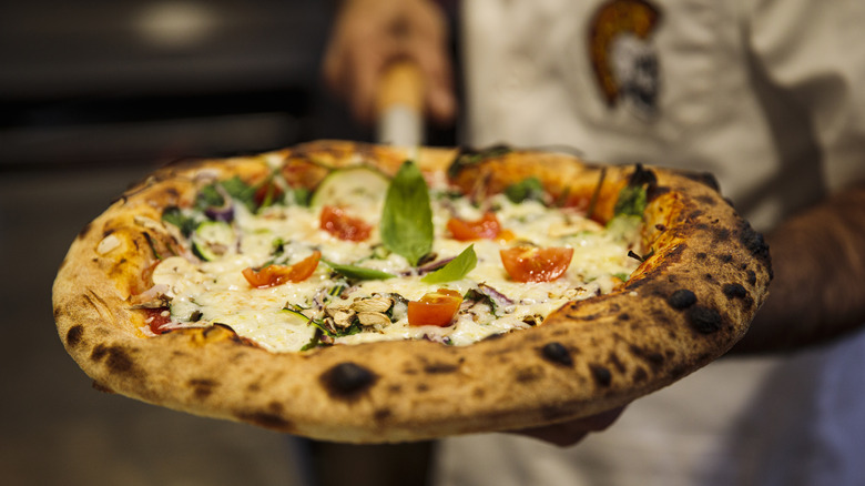 Man serving pizza 