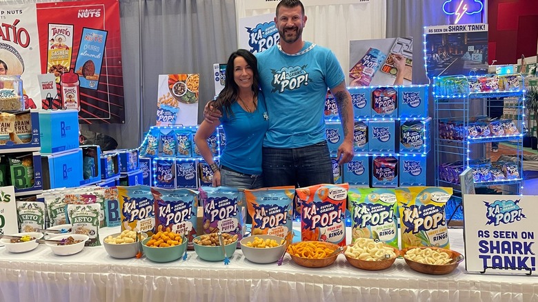 Dustin Finkel standing with Ka-Pop!'s snacks at trade show