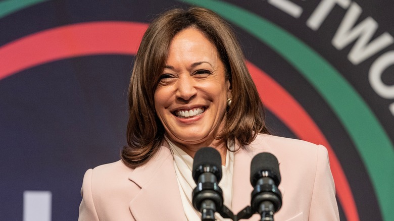 Vice president Kamala Harris smiling at podium