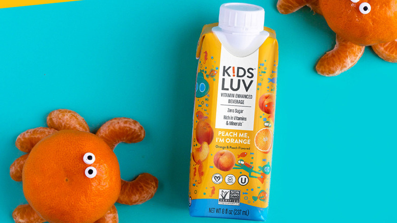 Tetra Pak container of KidsLuv vitamin beverage with crabs made from orange slices and peels