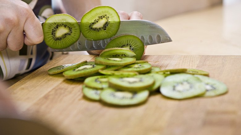 Cutting kiwi on cutting board