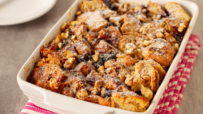 Bread pudding in dish with nuts and dried fruit