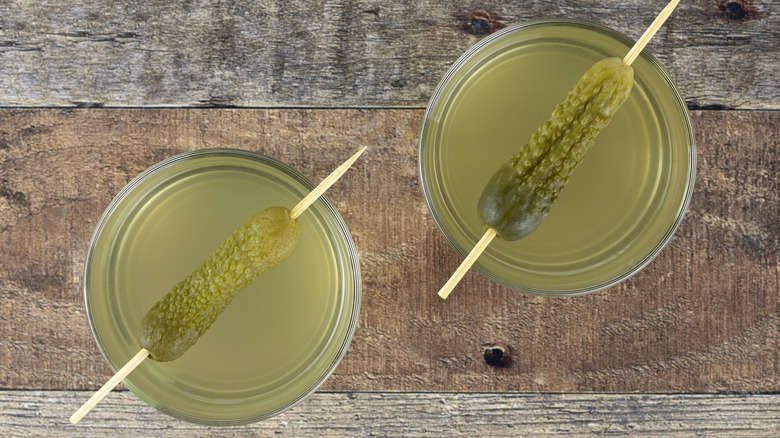 drinks with pickles on toothpicks as garnishes