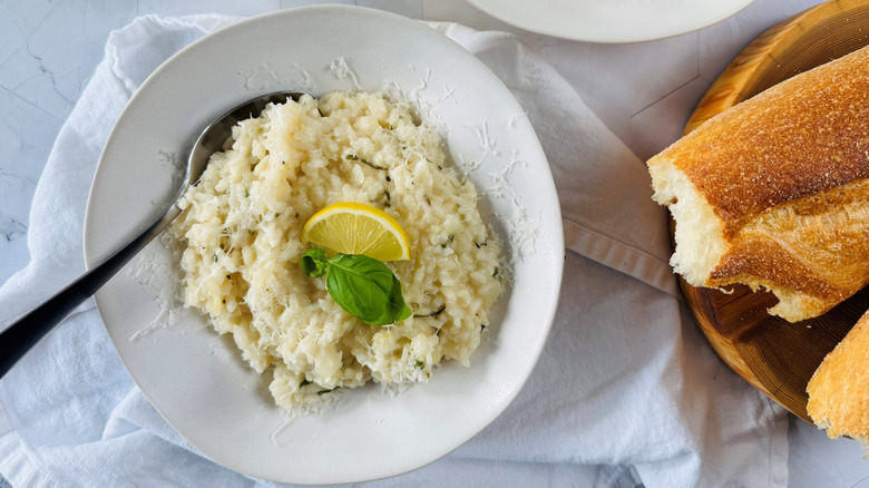 lemon basil risotto in bowl with baguette bread on side