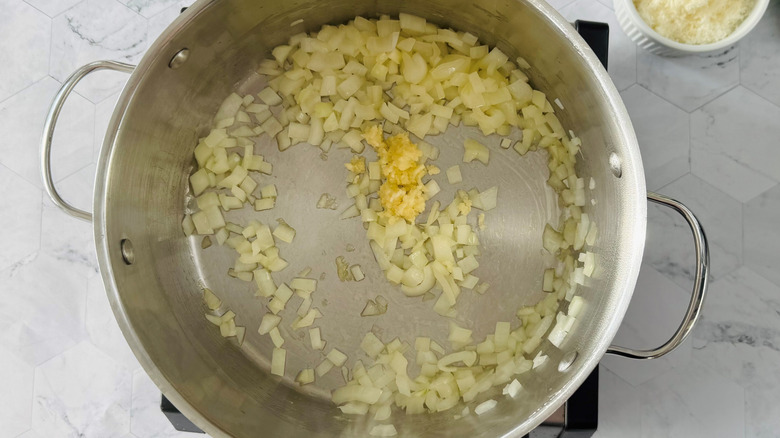 diced onions and minced garlic cooking in pot