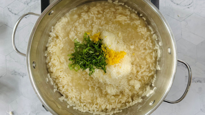 risotto with cheese, lemon zest, and herbs in pot