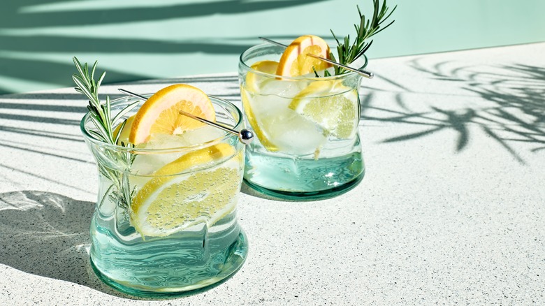 glasses of lemon water with herbs