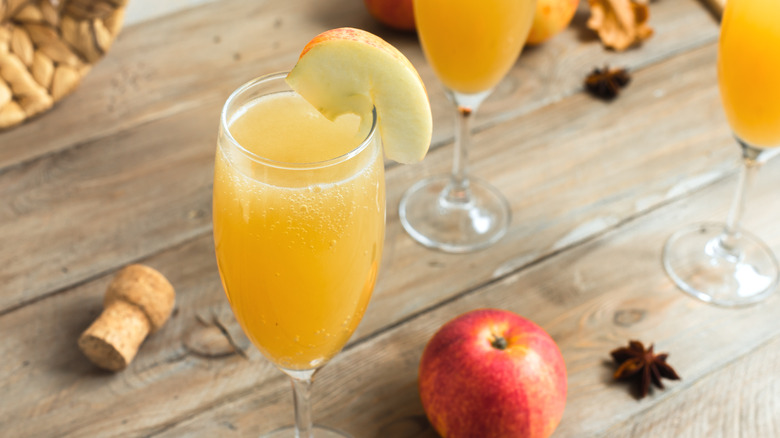 apple cider mimosas on a wooden table