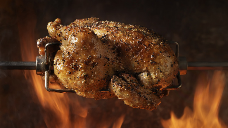 chicken roasting on a spit