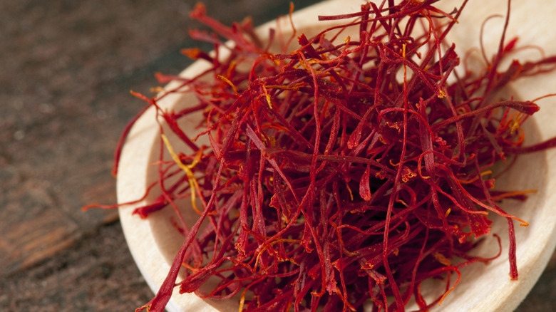 A wooden bowl full of saffron threads.