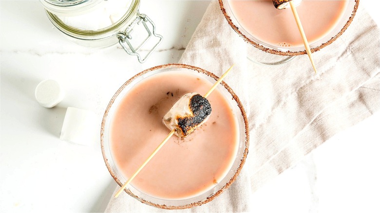 Top view of a martini with a skewered and roasted marshmallow on top