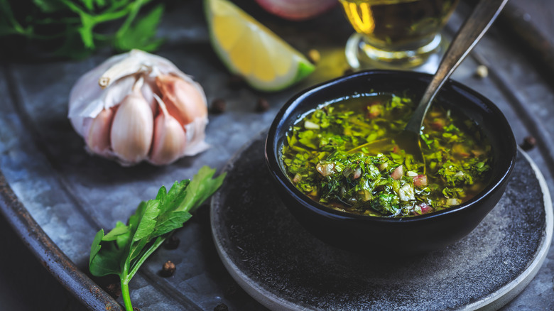 chimichurri sauce in black ramekin