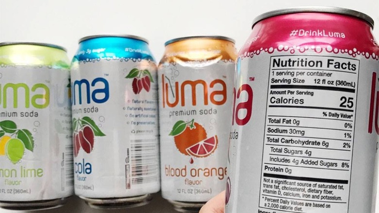 luma soda cans with one showing the nutritional info