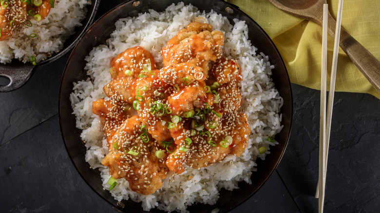 bowl of orange chicken with sesame seeds