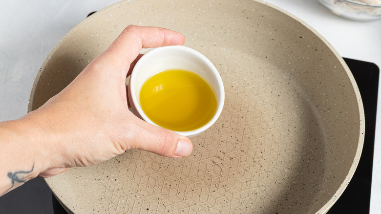 Pouring olive oil into a pan