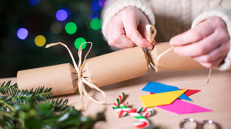 woman's hands making Christmas cracker