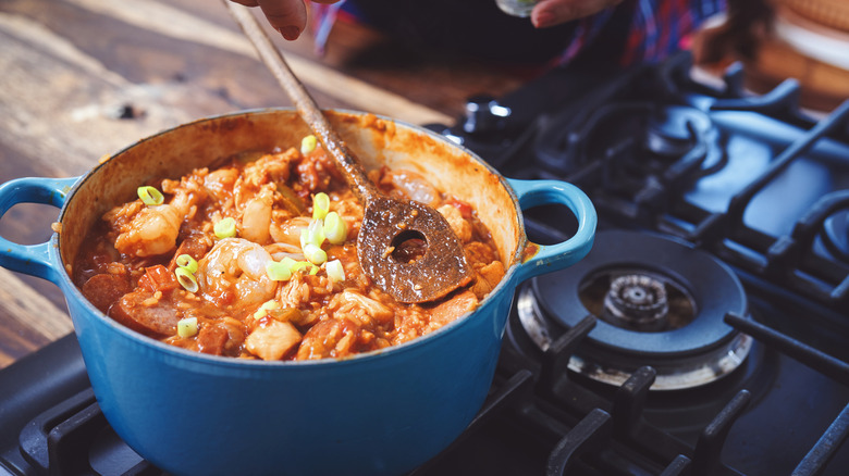 A pot of thick chicken stew is simmering on the stove.