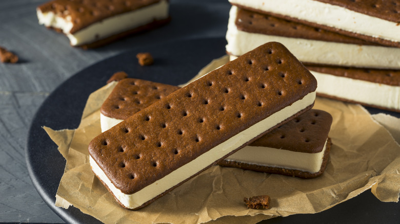 Vanilla ice cream sandwiches with chocolate cookies stacked on plate