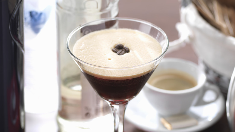 Espresso martini with bottles and beans in background