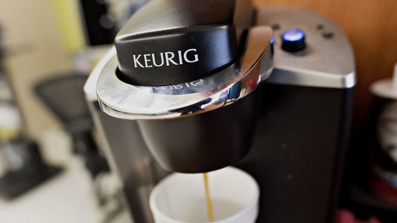 A Keurig machine brewing coffee