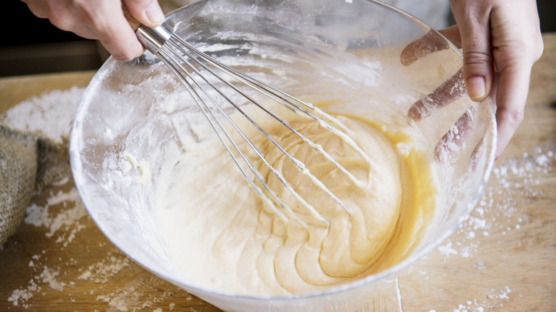 whipping cake batter with whisk