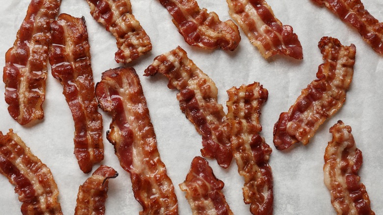 Strips of cooked bacon on wax paper