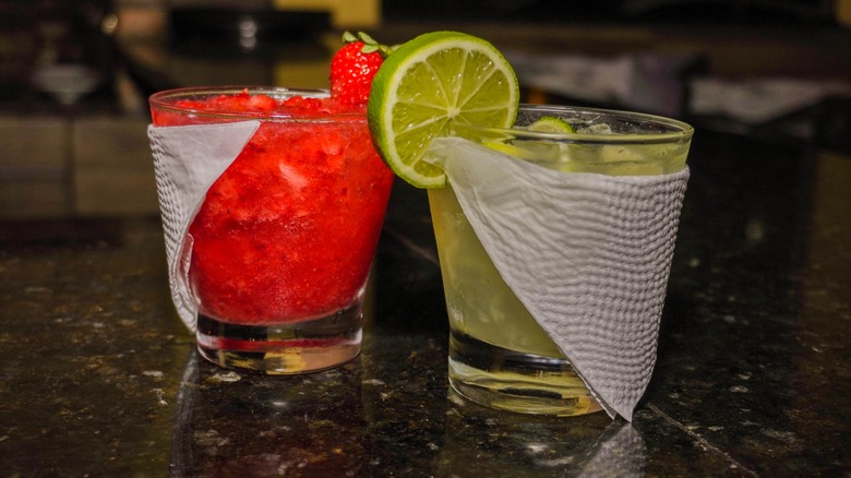 a traditional and strawberry caipirinha 