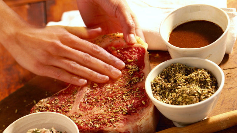 Skirt steak marinating in glass dish