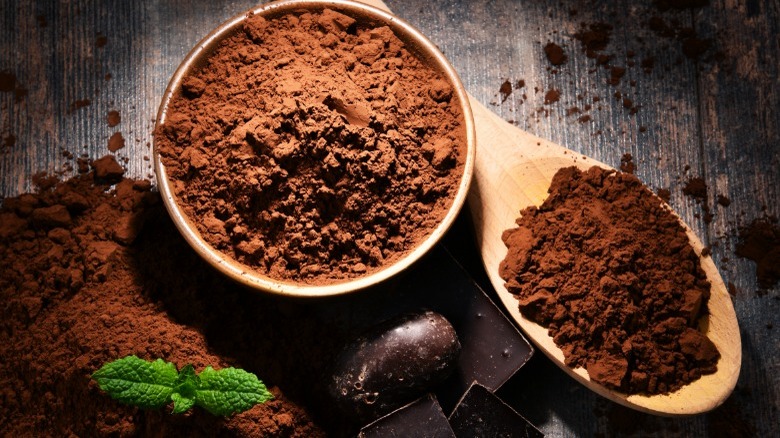 Cocoa powder in a wooden bowl and spoon