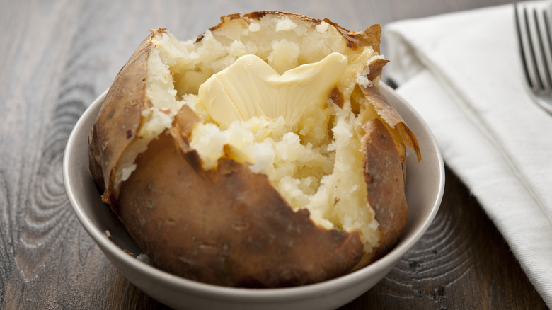 baked russet potato with melting butter