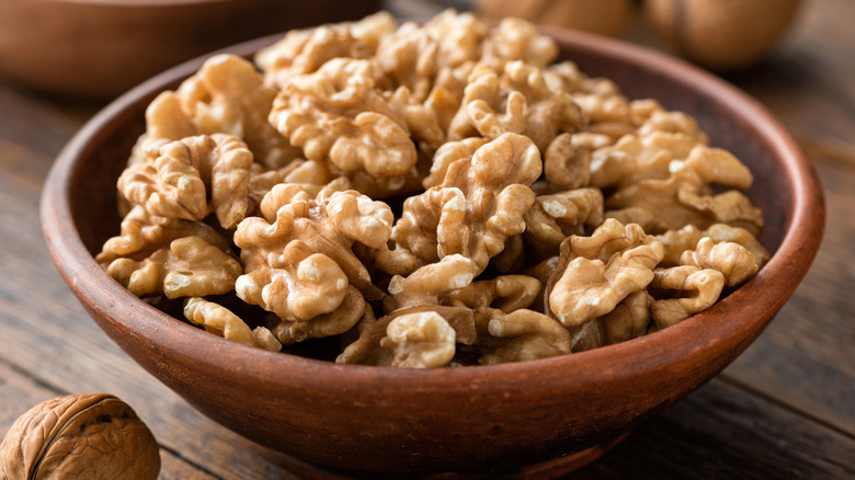 Wooden bowl of shelled walnuts