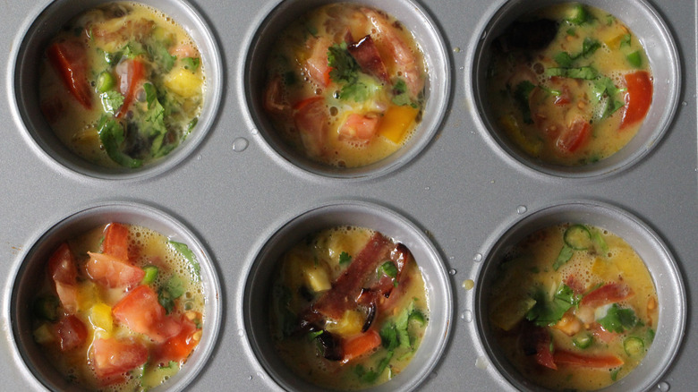 Raw egg muffin mixture in muffin tins