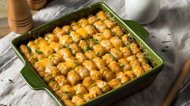 A tater-tot casserole, or hot dish, in a pan