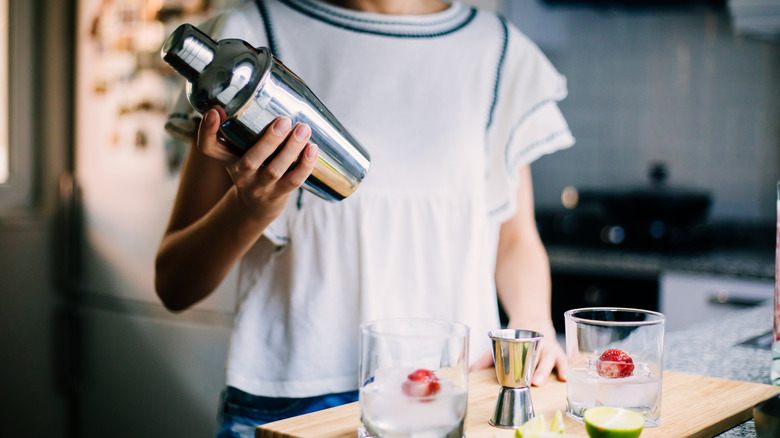 Person holds cocktail shaker