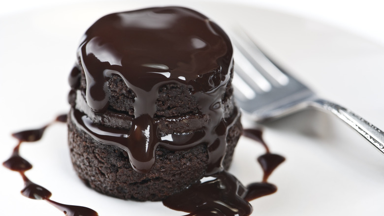 melted chocolate frosting on small cake
