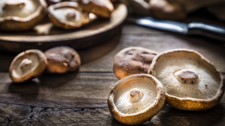 shitake mushrooms on wooden cutting board