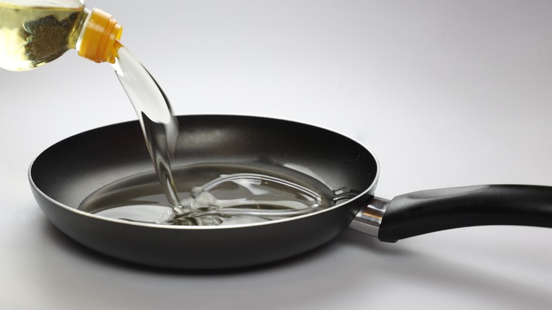Oil pouring into frying pan