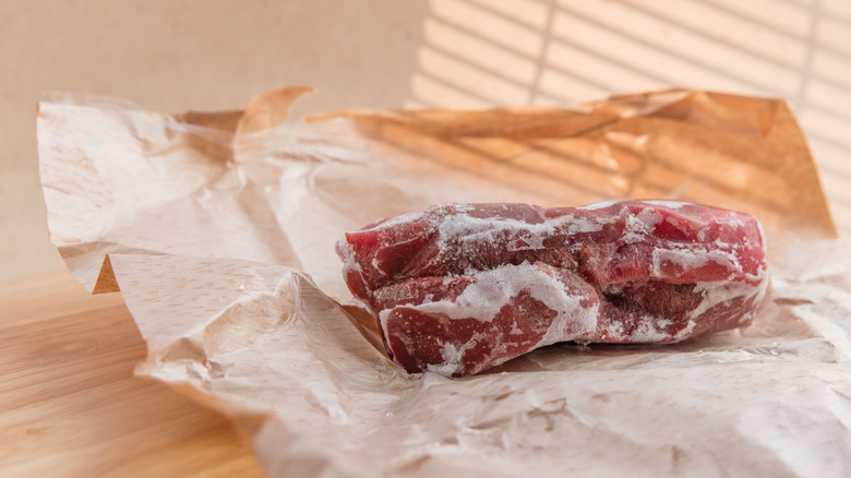 Frozen steaks thawing on counter