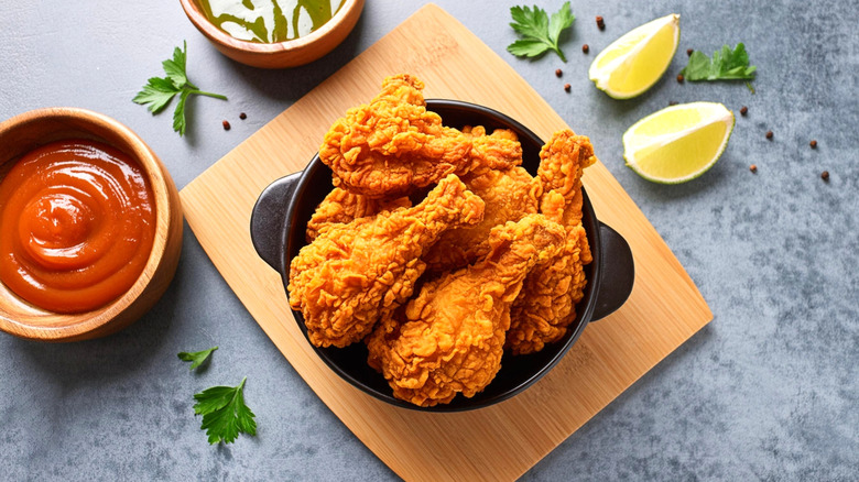 bowl of fried chicken with ketchup and garnish