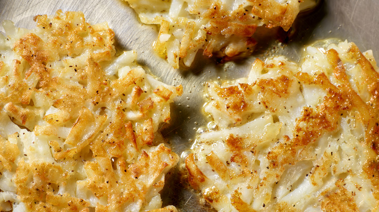 close-up of cooked hash browns on a cutting board