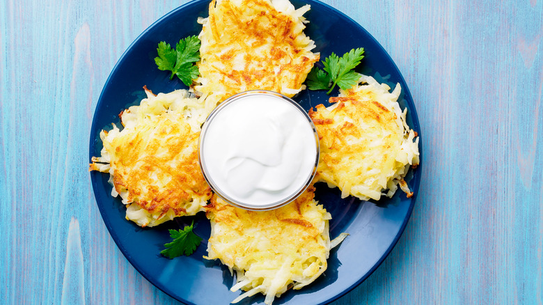 hash brown patties with bowl of sour cream
