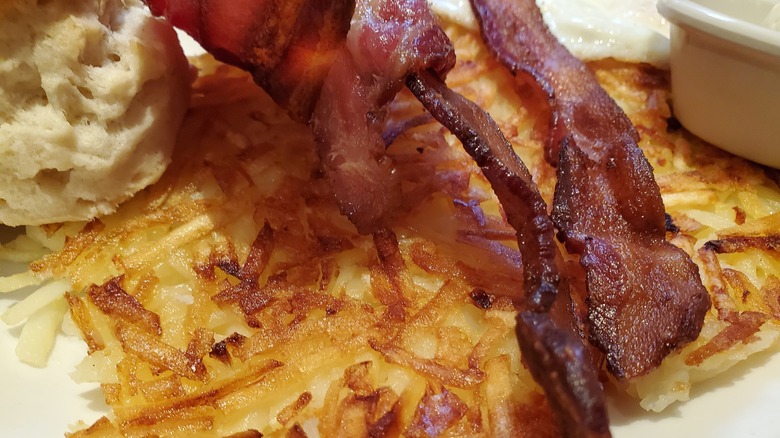 hash browns with bacon and a biscuit