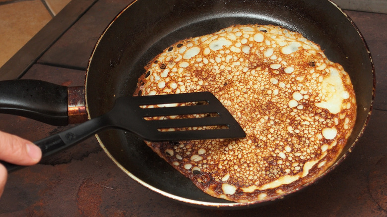 flattening pancake with spatula
