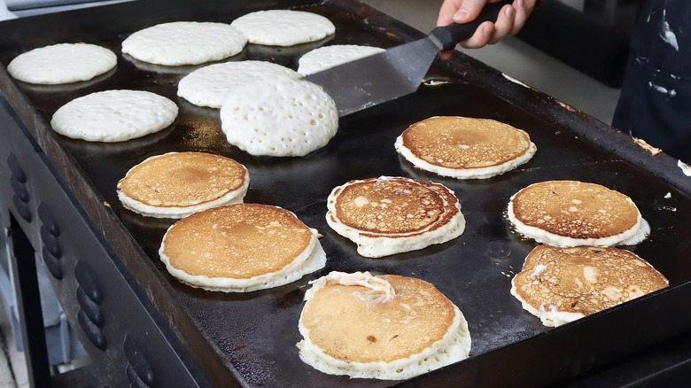 multiple pancakes being cooked at once
